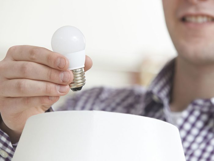 man holding a lightbulb